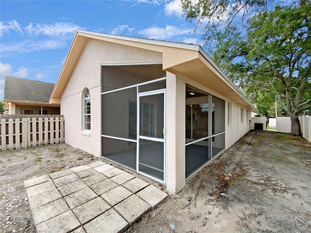 view of property exterior featuring a sunroom