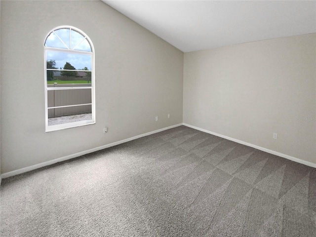 unfurnished room featuring carpet flooring and lofted ceiling