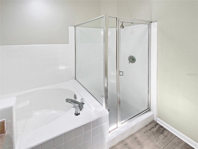 bathroom featuring tile patterned flooring and plus walk in shower