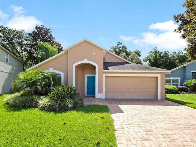 view of front of home with a garage and a front yard