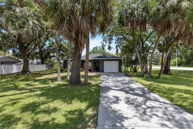 view of front of home with a garage and a front lawn