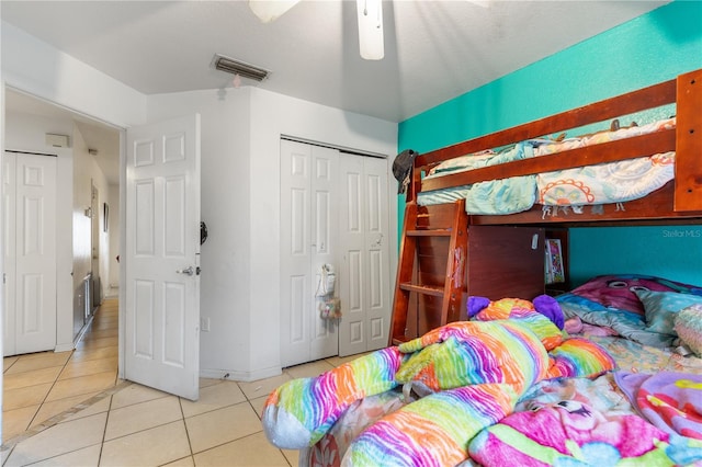 tiled bedroom with a closet and ceiling fan