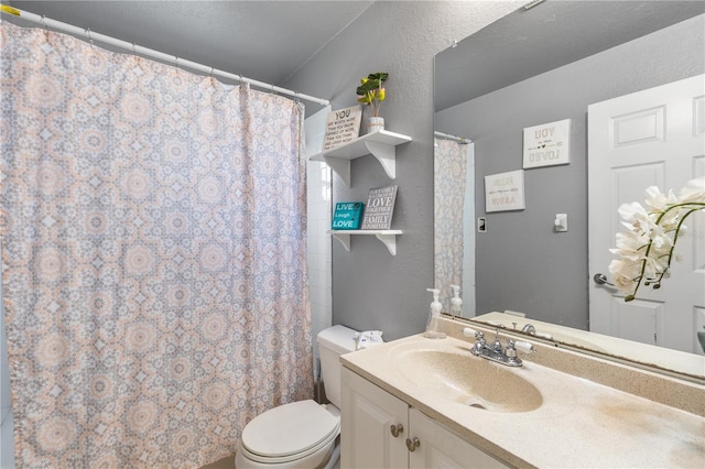 bathroom with vanity, walk in shower, a textured ceiling, and toilet