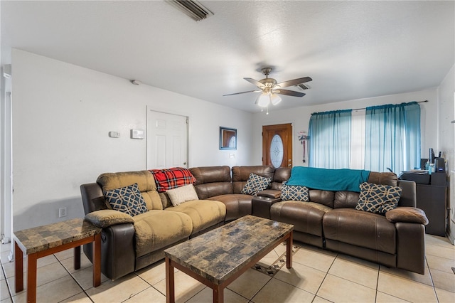 tiled living room with ceiling fan