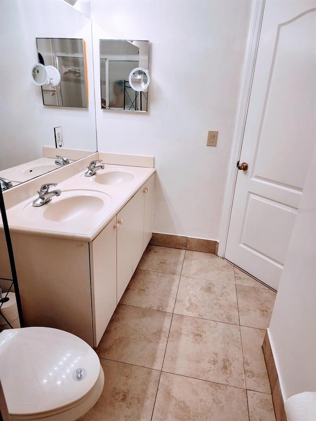 bathroom with tile patterned floors and double vanity