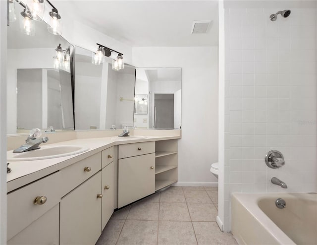 full bathroom with toilet, vanity, tile patterned floors, and tiled shower / bath