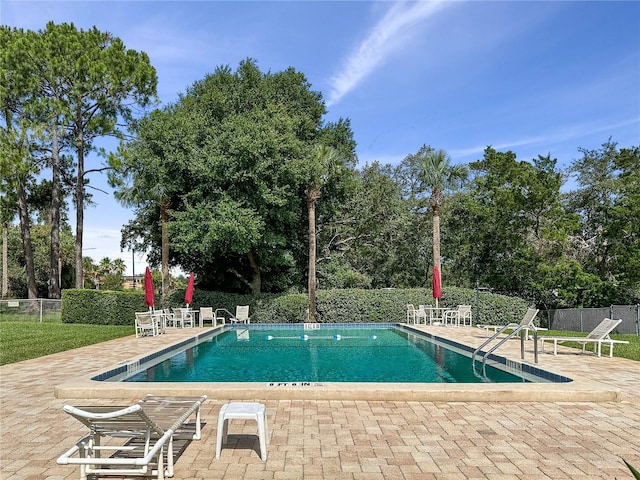 view of swimming pool featuring a patio area