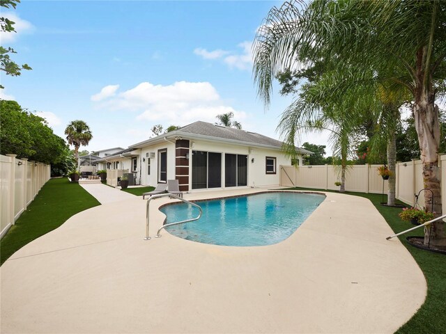 view of pool with a fenced in pool, a sunroom, a fenced backyard, and a patio area