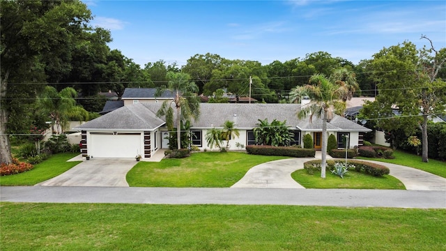 view of front of house with a garage, driveway, and a front yard