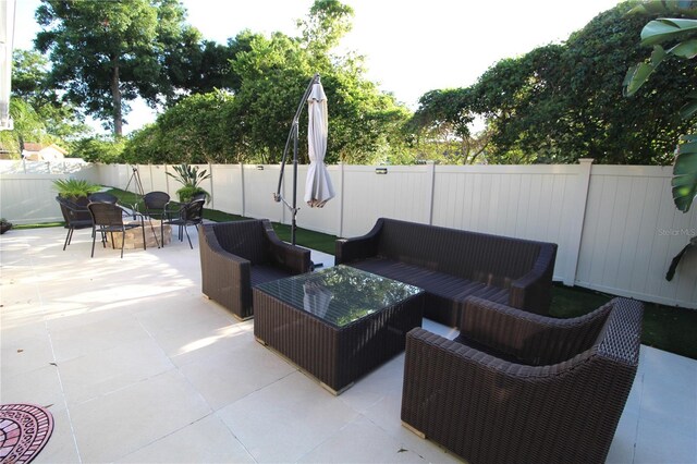 view of patio with an outdoor living space and a fenced backyard