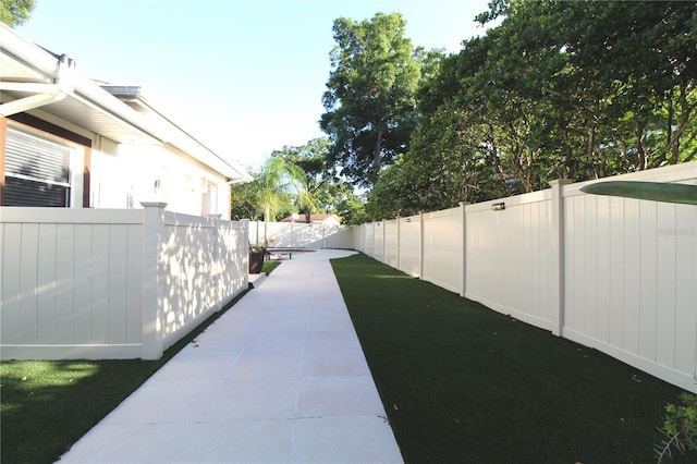 view of yard featuring a patio area and a fenced backyard