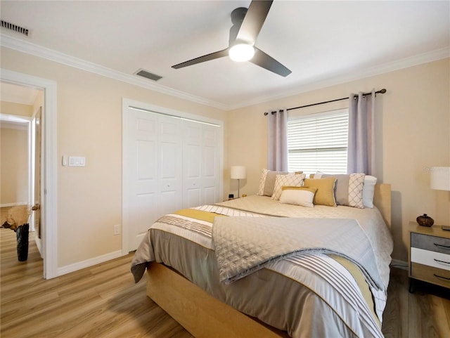 bedroom featuring visible vents, a closet, and light wood finished floors