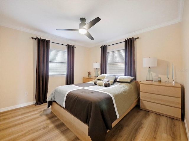 bedroom featuring multiple windows, light wood-type flooring, and ornamental molding