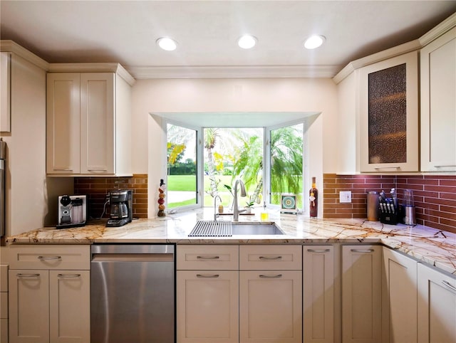 kitchen featuring light stone counters, a sink, glass insert cabinets, stainless steel dishwasher, and tasteful backsplash