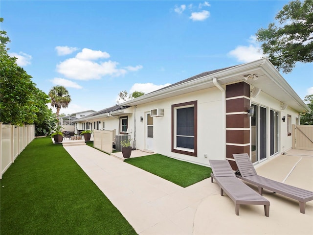 back of property featuring a patio area, a fenced backyard, stucco siding, and a yard