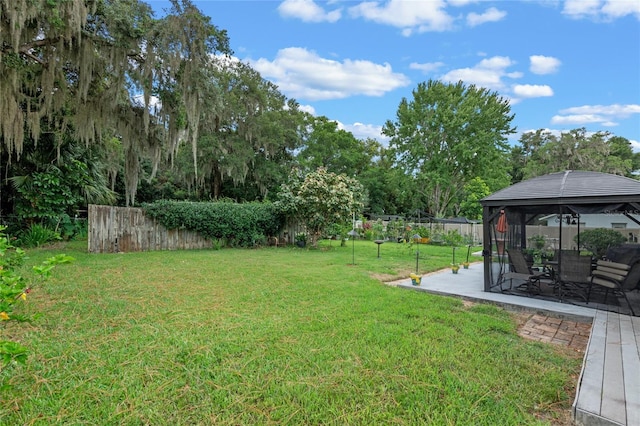 view of yard featuring a gazebo, a patio area, and fence