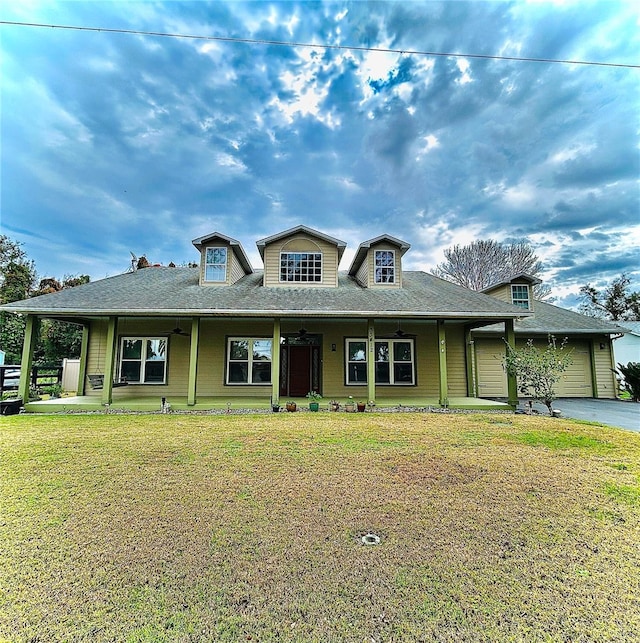 view of front facade with a front lawn, a porch, a garage, and driveway