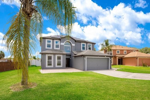 view of front of home featuring solar panels and a front yard