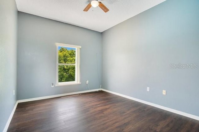 unfurnished room with dark hardwood / wood-style floors, ceiling fan, and a textured ceiling