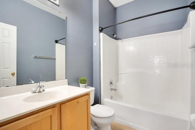 full bathroom with shower / bathing tub combination, vanity, toilet, and tile patterned floors