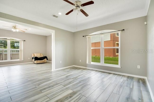 unfurnished room with ceiling fan and light hardwood / wood-style floors