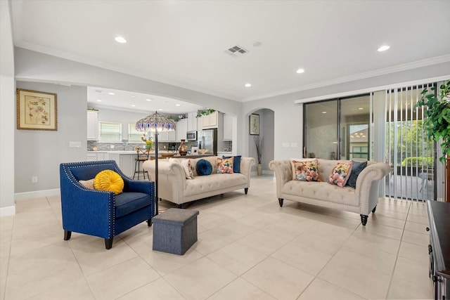 living room with light tile patterned floors, sink, crown molding, and a notable chandelier