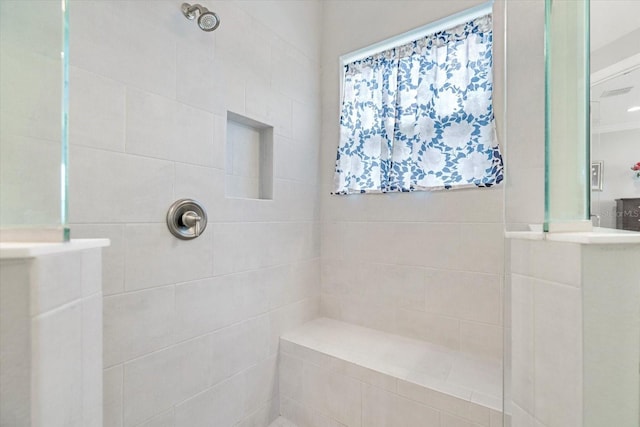 bathroom with a tile shower