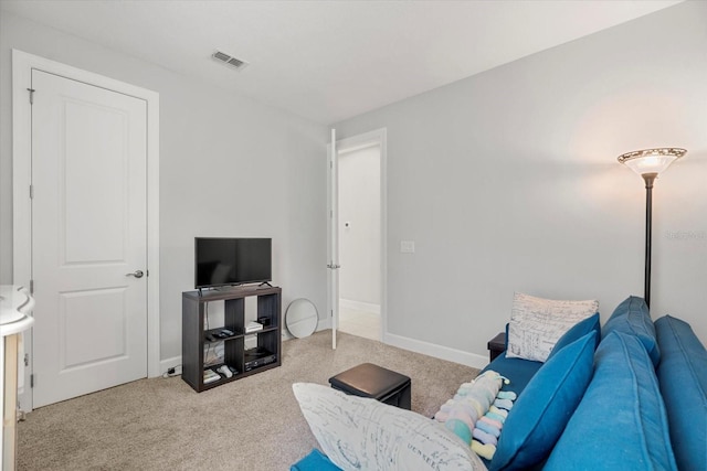 sitting room featuring light carpet