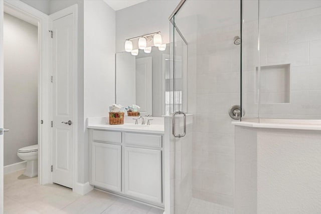 bathroom with tile patterned flooring, vanity, toilet, and a shower with shower door