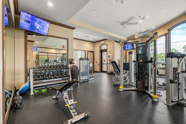 workout area with a textured ceiling, ceiling fan, and ornamental molding