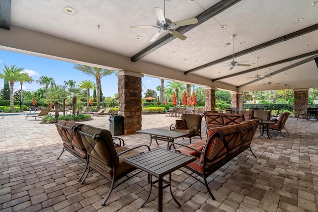 view of patio featuring outdoor lounge area, ceiling fan, and a community pool