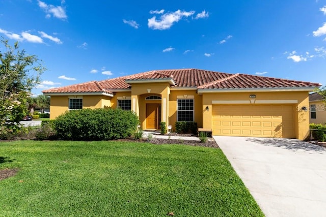 mediterranean / spanish home featuring a front lawn and a garage