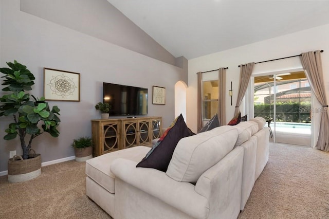 living room featuring carpet, ceiling fan, and lofted ceiling