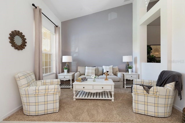 carpeted living room featuring vaulted ceiling