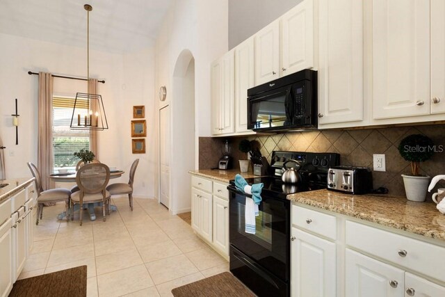 4036 Oakrise Loop, Davenport, FL 33837 - kitchen featuring tasteful backsplash, black appliances, light tile patterned floors, arched walkways, and white cabinetry