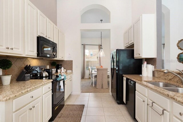 4036 Oakrise Loop, Davenport, FL 33837 - kitchen featuring black appliances, backsplash, a sink, and white cabinets