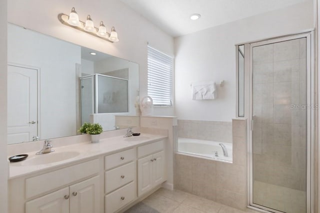 bathroom with tile flooring, double vanity, and separate shower and tub