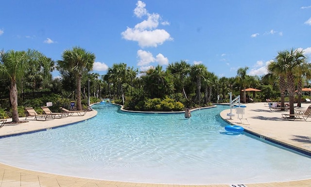 4036 Oakrise Loop, Davenport, FL 33837 - community pool featuring a patio