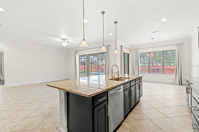 kitchen featuring an island with sink, decorative light fixtures, sink, and dishwasher