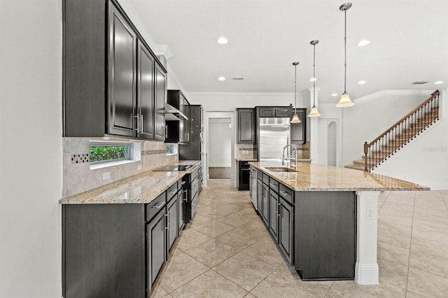 kitchen featuring a large island, hanging light fixtures, stainless steel built in fridge, crown molding, and light stone countertops