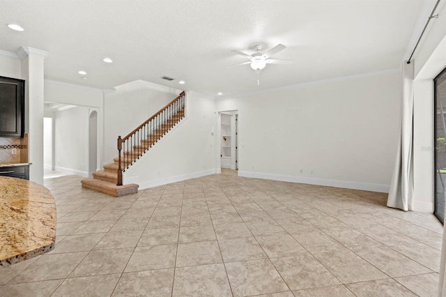 unfurnished living room with ceiling fan, light tile patterned floors, and ornamental molding