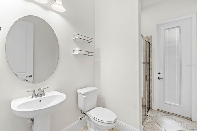 bathroom with tile patterned flooring, a shower with door, toilet, and sink