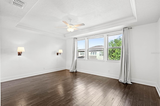 spare room featuring ceiling fan, a raised ceiling, dark wood-type flooring, and a textured ceiling