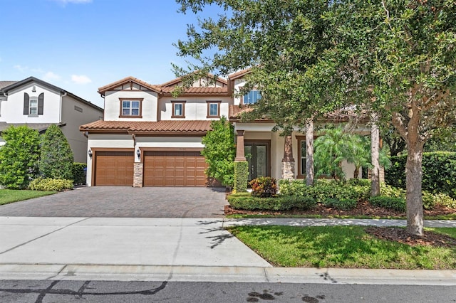 mediterranean / spanish-style home featuring a garage