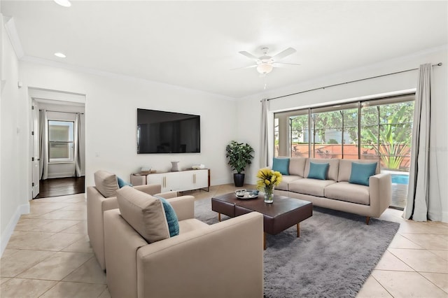 tiled living room with ceiling fan and ornamental molding