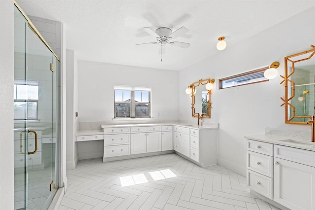 bathroom with parquet flooring, ceiling fan, an enclosed shower, and vanity