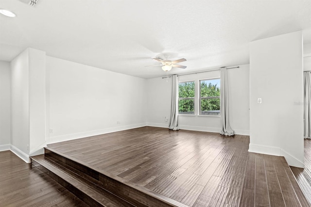 unfurnished room featuring ceiling fan and dark wood-type flooring