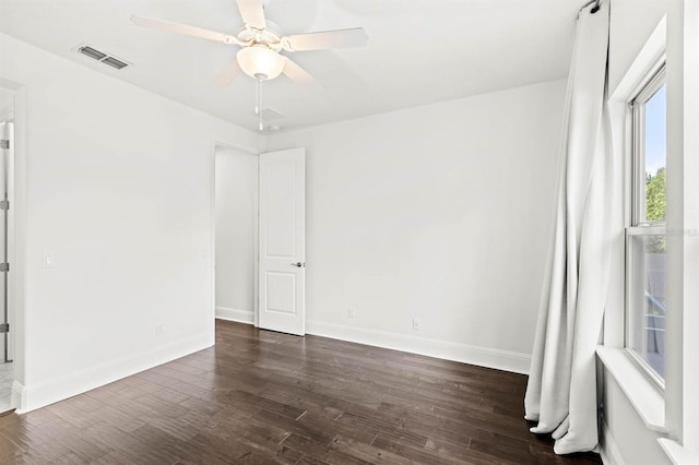 unfurnished room with dark hardwood / wood-style flooring and ceiling fan