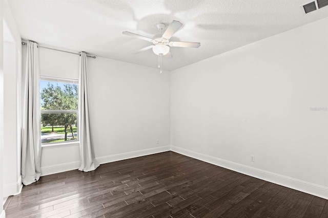 unfurnished room featuring ceiling fan, a textured ceiling, and dark wood-type flooring