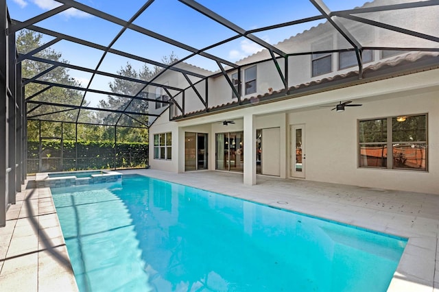 view of pool featuring ceiling fan, glass enclosure, and a patio